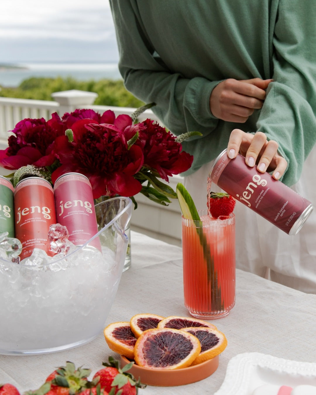 Jeng’s alcohol-free rhubarb cucumber drink being poured into a glass, showcasing a refreshing zero-proof sip.
