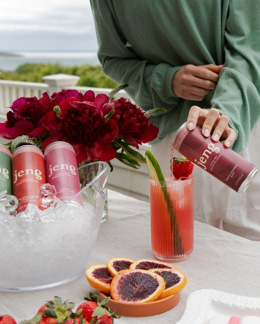 Jeng’s alcohol-free rhubarb cucumber drink being poured into a glass, showcasing a refreshing zero-proof sip.