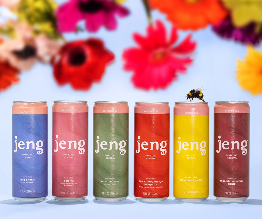 Six colorful Jeng Sparkling THC Cocktail cans arranged in a row with bright flowers overhead.