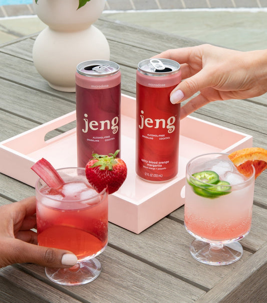 Jeng margaritas by the pool with strawberry, jalapeño slices, and a citrus garnish.