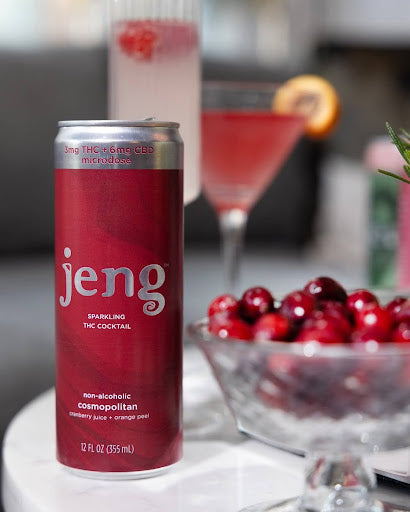 Jeng non-alcoholic 3mg THC cosmopolitan cocktail can with fresh cranberries in a bowl, set in a kitchen.