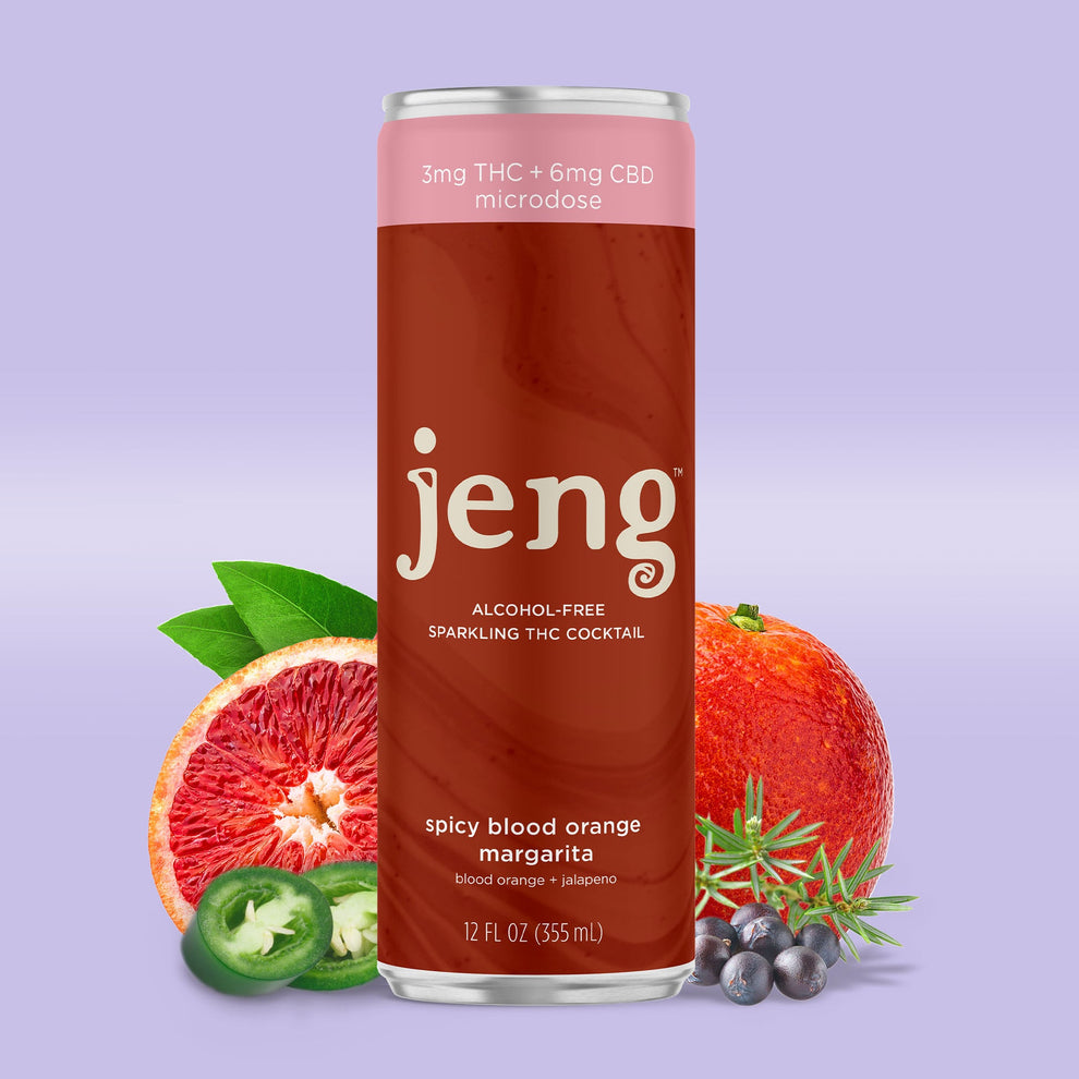 Jeng Spicy Blood Orange Margarita can with chili flakes, blood orange wedges, and salted rim glass.